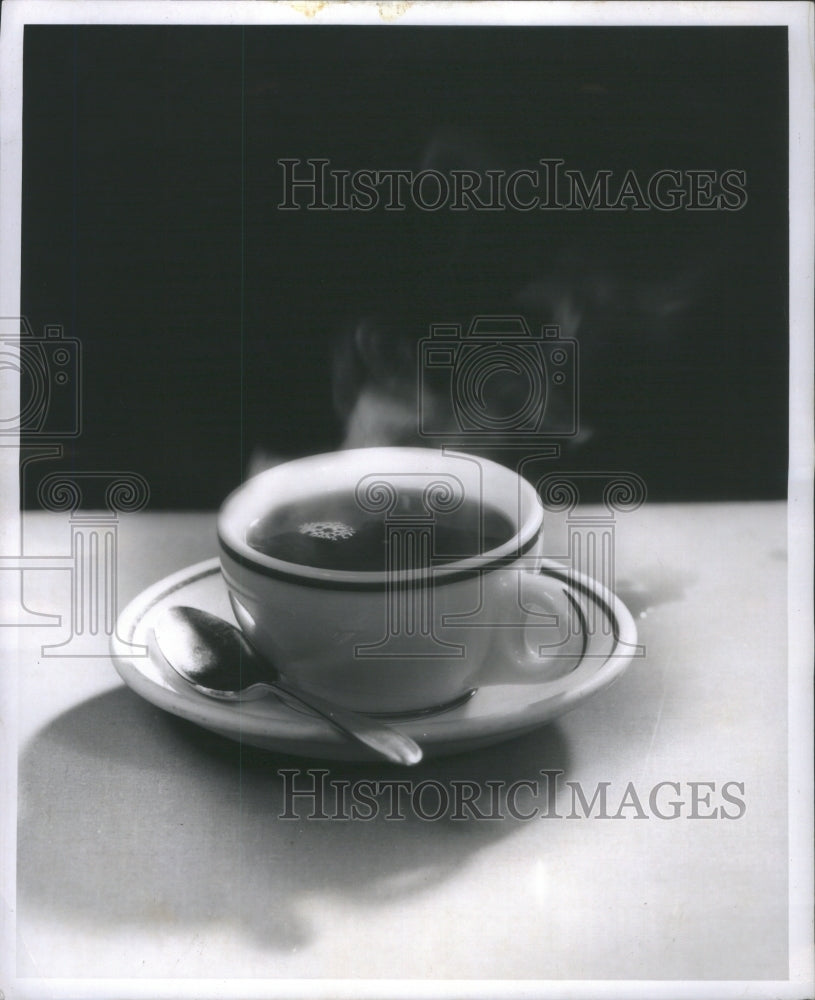 1957 Press Photo Cup of a Hot Drink with a Spoon Steami- RSA13347 - Historic Images