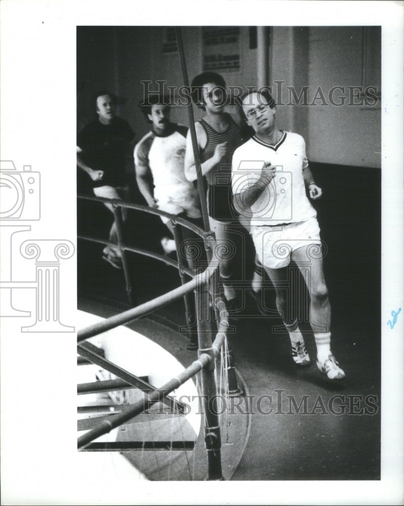 1980 Press Photo Four Male Joggers Indoor Track - Historic Images