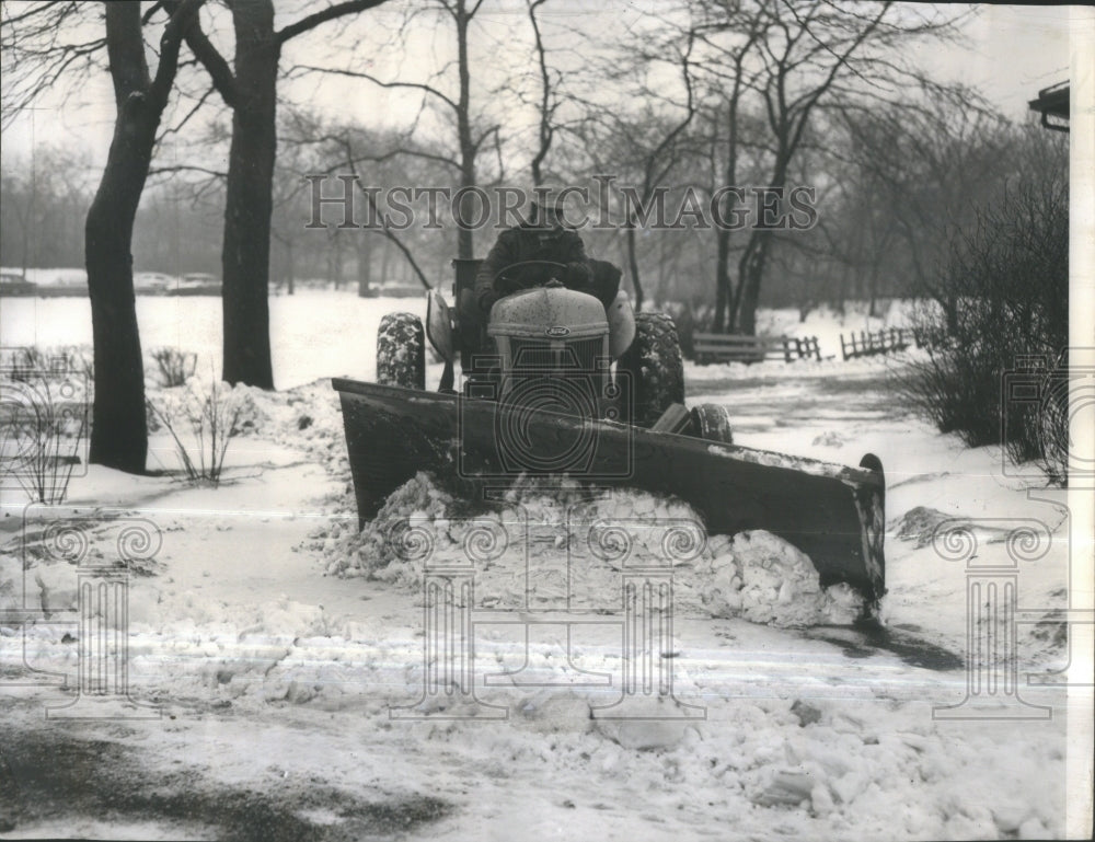 1959 Maintenance man clears snow with plow. - Historic Images