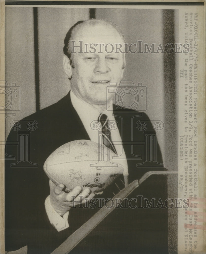 1975 Pres. Ford handles a football as he addresses Football coaches - Historic Images