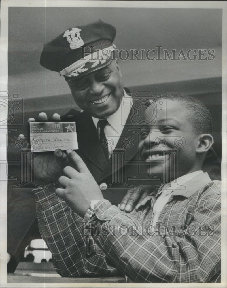 1965 Commander Robert Harness looks on as Kenneth Williams - Historic Images