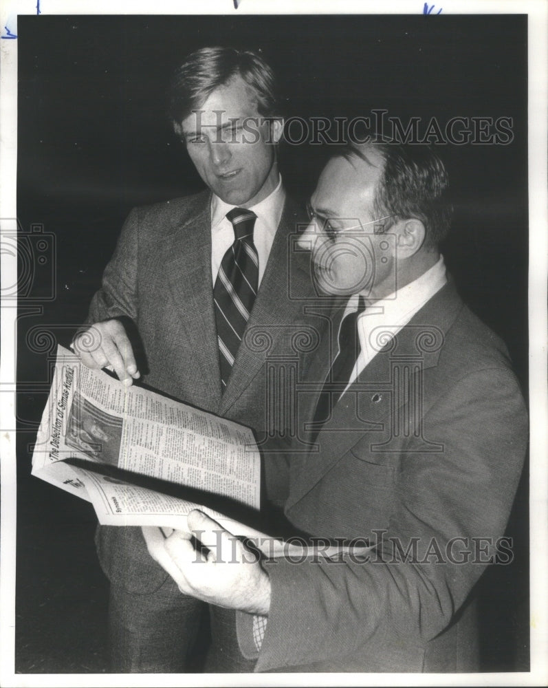 1977 Jim Hogs and Simas Kudirka look over a special supplement - Historic Images