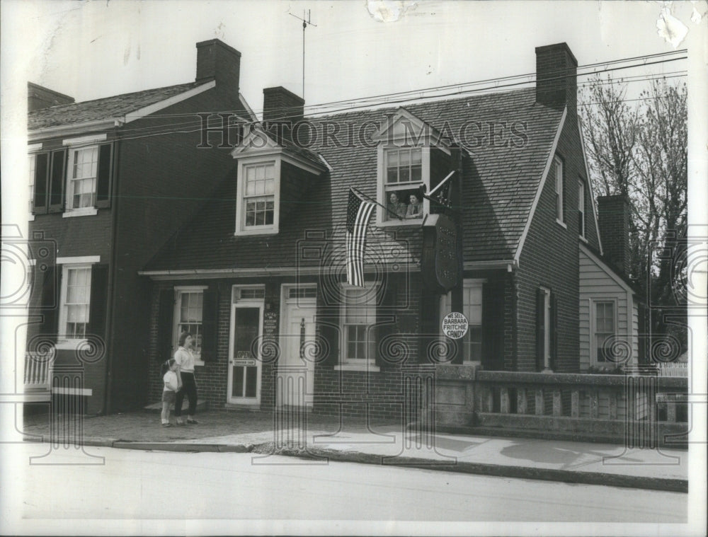 1961 Flag hangs from the attic window of the Barbara Fritchie house - Historic Images