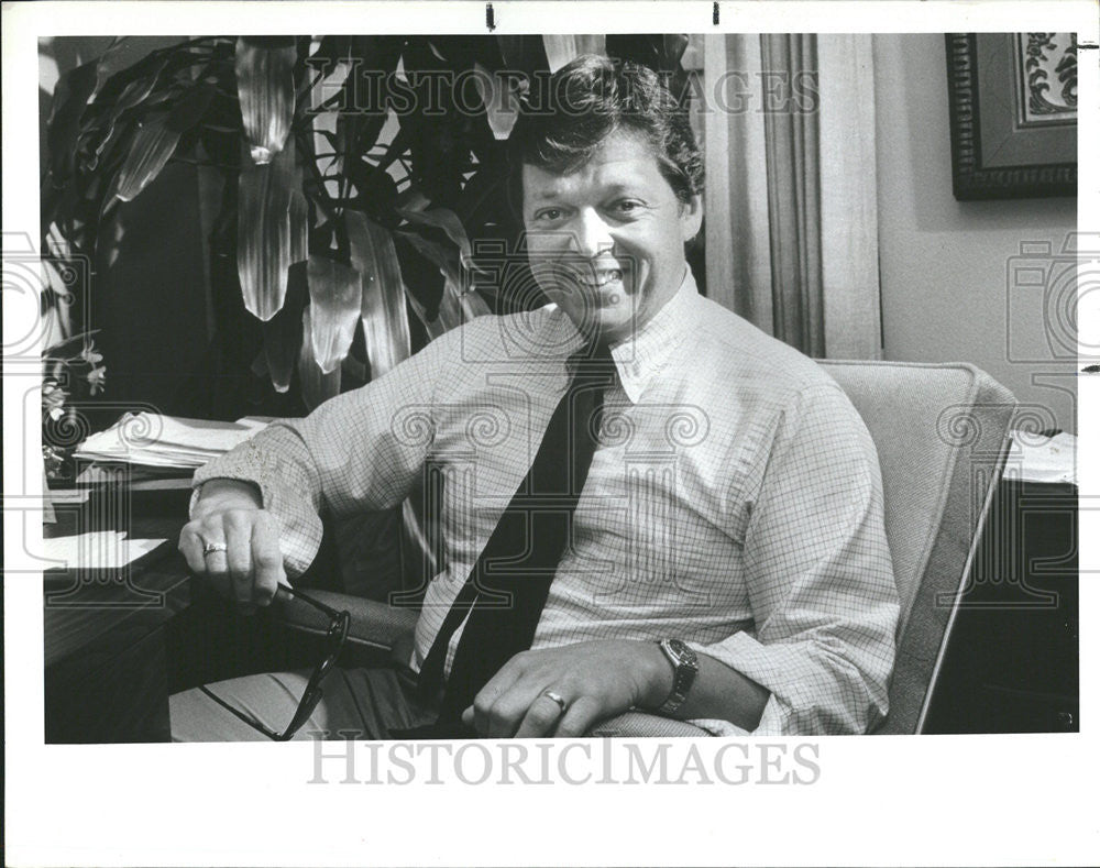 Press Photo Doctor James Adams officer room modern spectacles hold pose - Historic Images