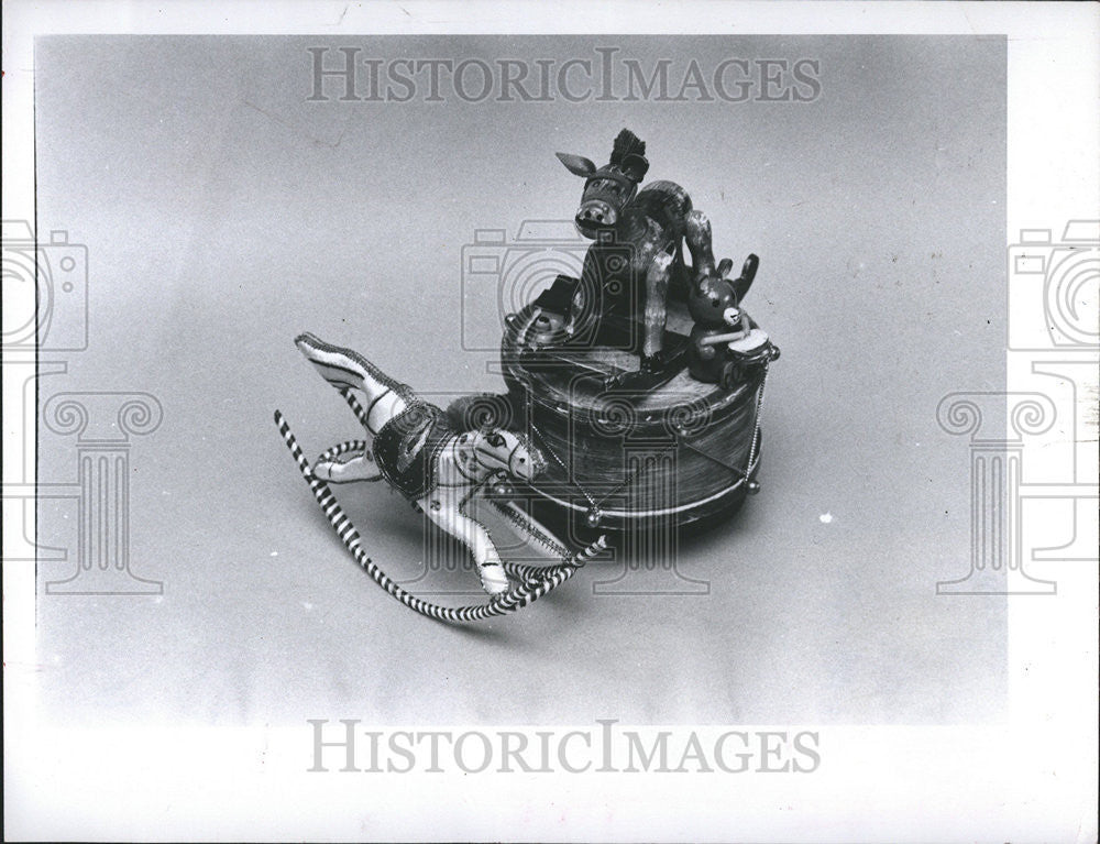 1981 Press Photo Tiny Chinese rocking horse poses against donkey and drum music - Historic Images