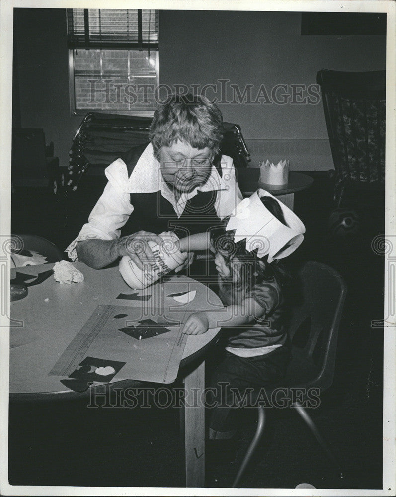 1975 Press Photo Mrs.Margaret Fletcher helping one year old child. - Historic Images