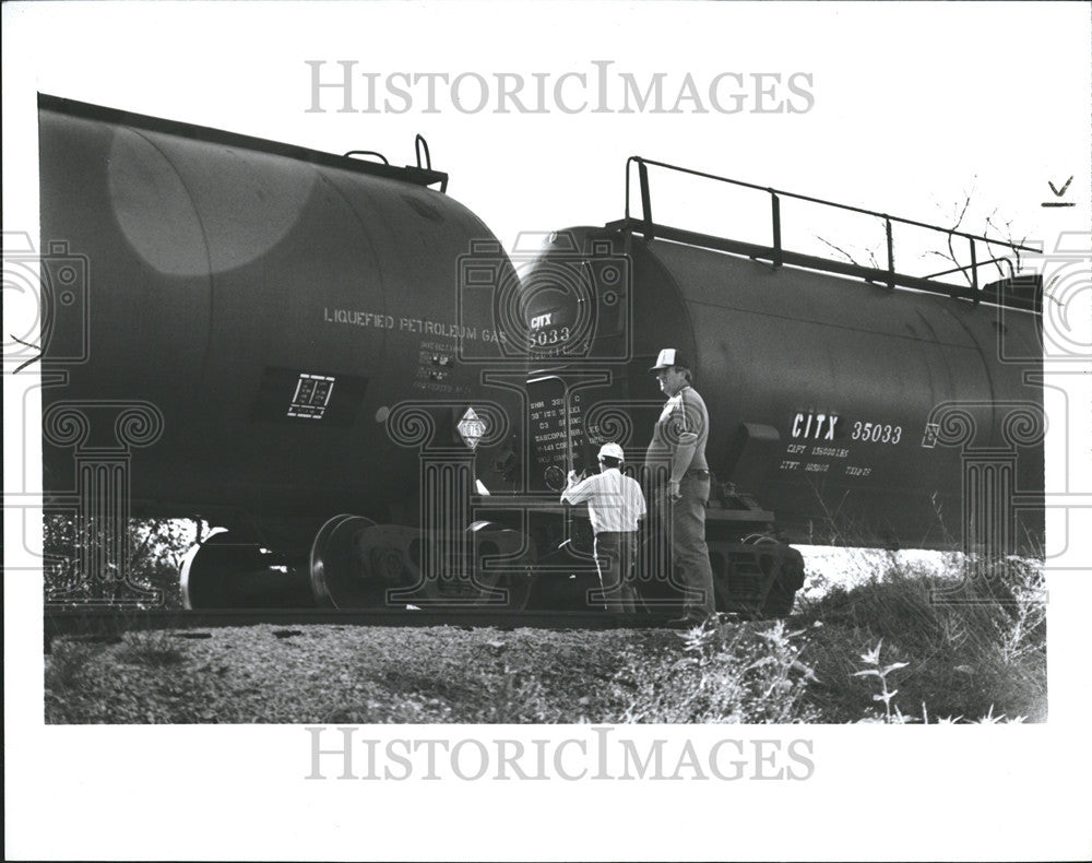 1988 Press Photo Railroad Personnel Check Two Tanker Car Involved in Derailment - Historic Images