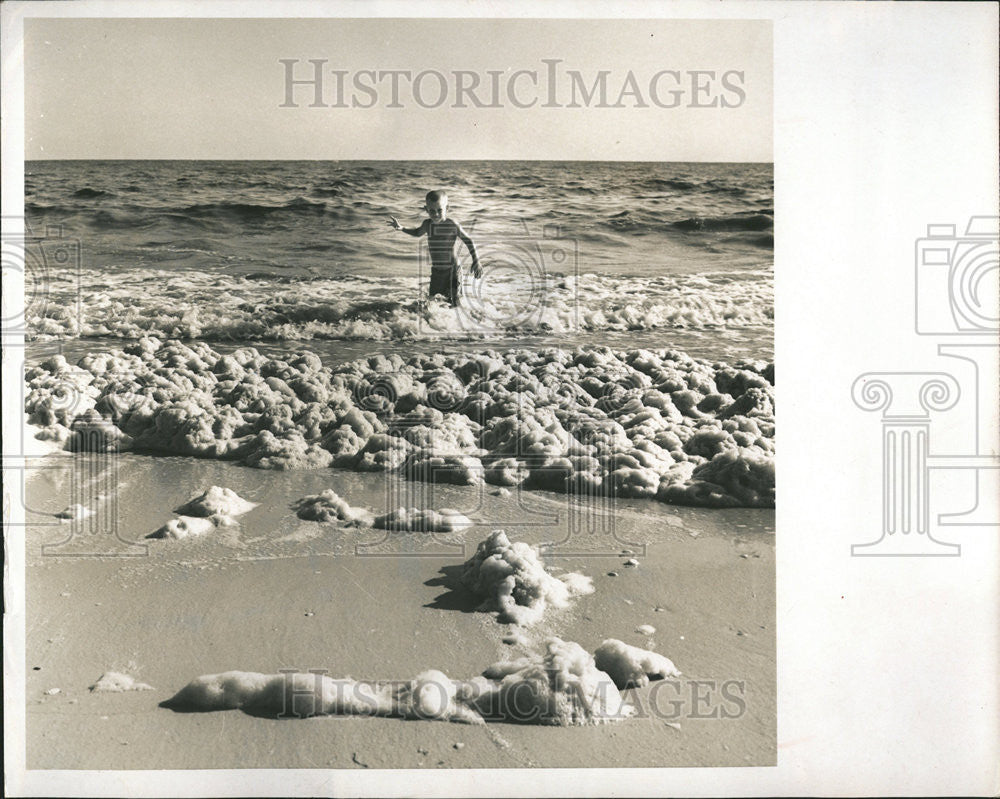 1967 Press Photo Boy Playing Algae Foam Beach - Historic Images