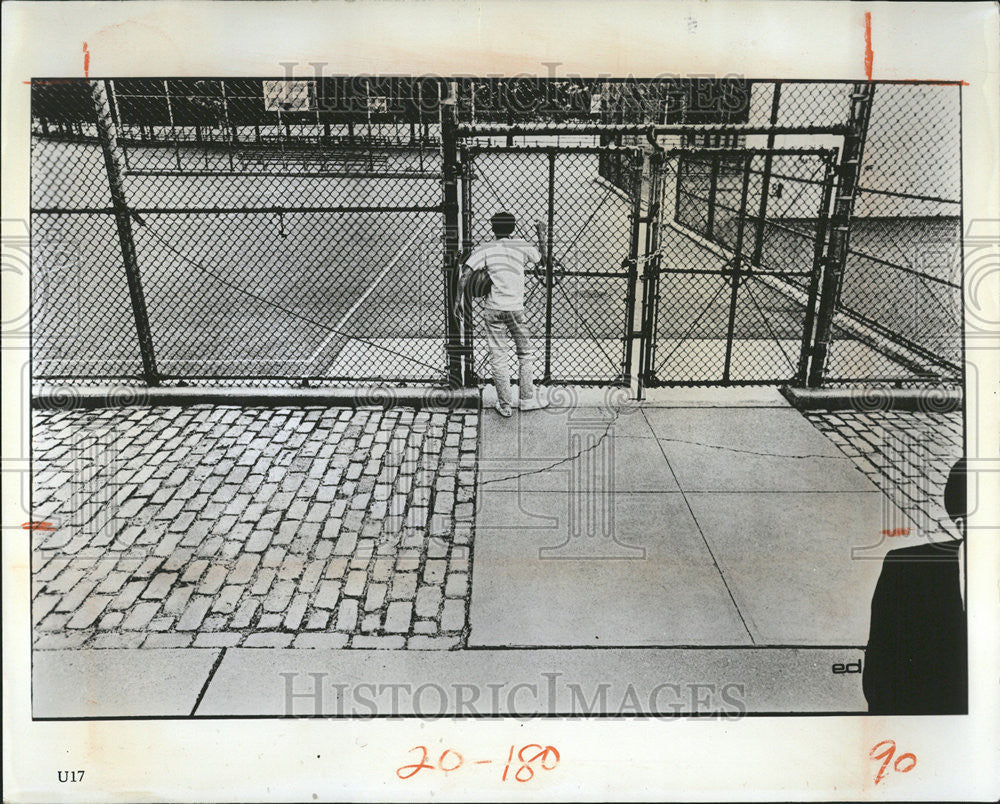 1967 Press Photo Student locked gate Play ground bag hand hanging Snap - Historic Images