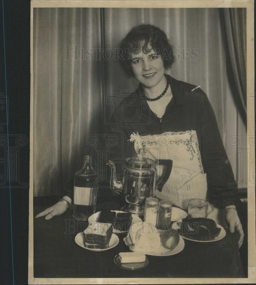 Woman behind table full of food-Historic Images