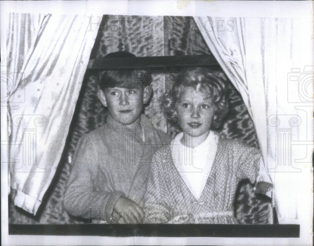 1956 Prince Charles and Princess Anne in PJs on a train - Historic Images