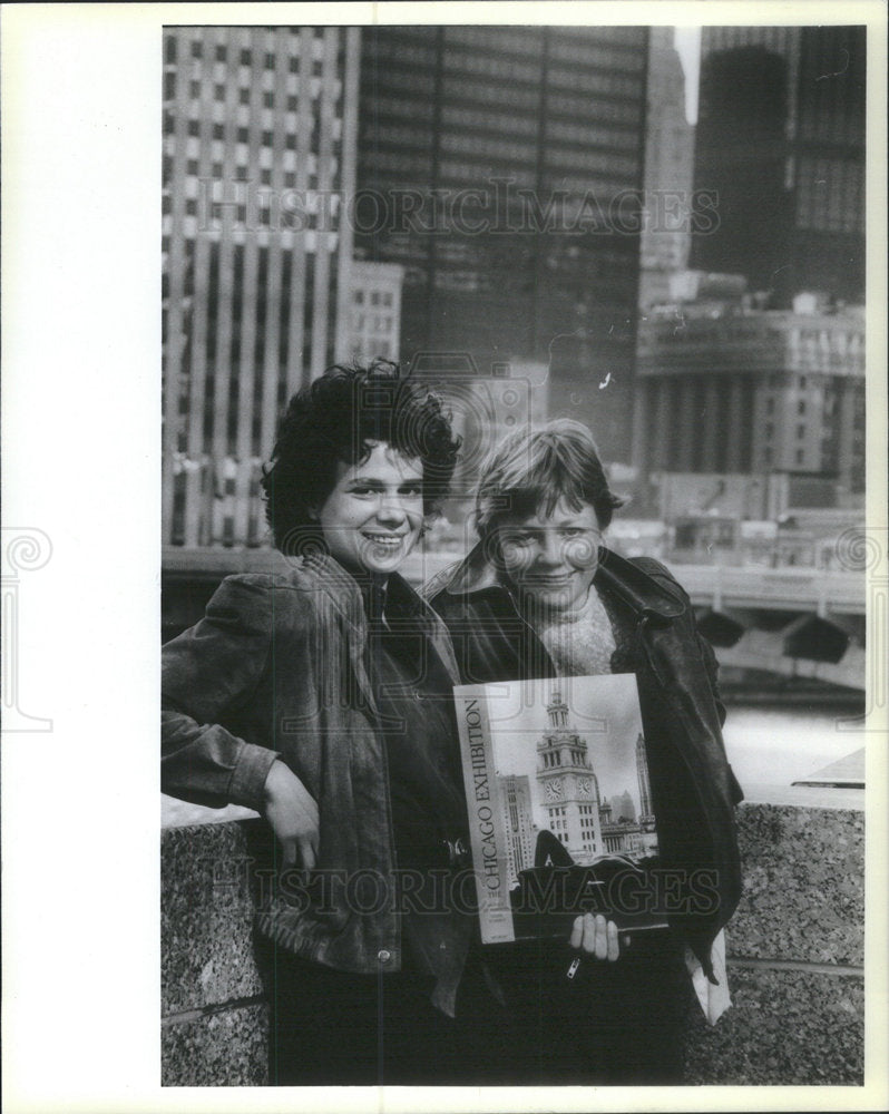 Press Photo Two Women With A Book of Chicago Exhibition - Historic Images