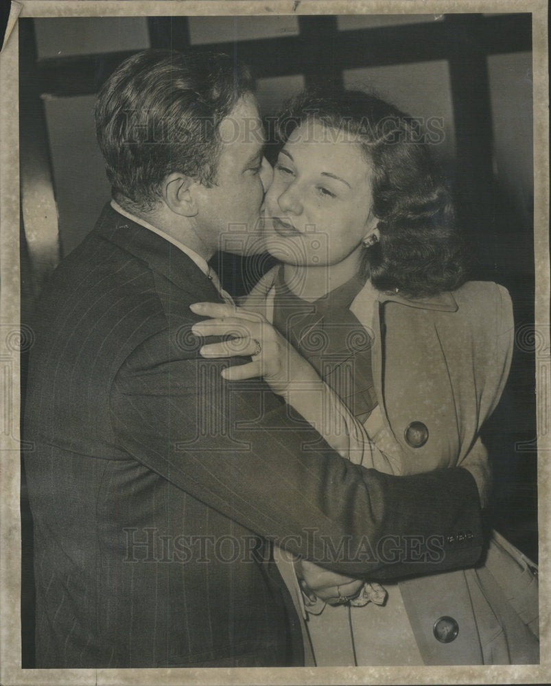 1948 Mary A. Panozzo is embraced by her husband after not guilty - Historic Images