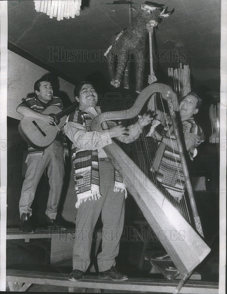 1967 Warming up for the annual posada at the Cafe Azteca - Historic Images