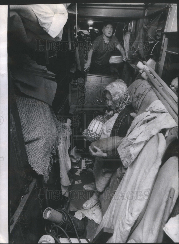 1974 Press Photo Louis Haas surveys damage in his antiques warehouse while his m - Historic Images