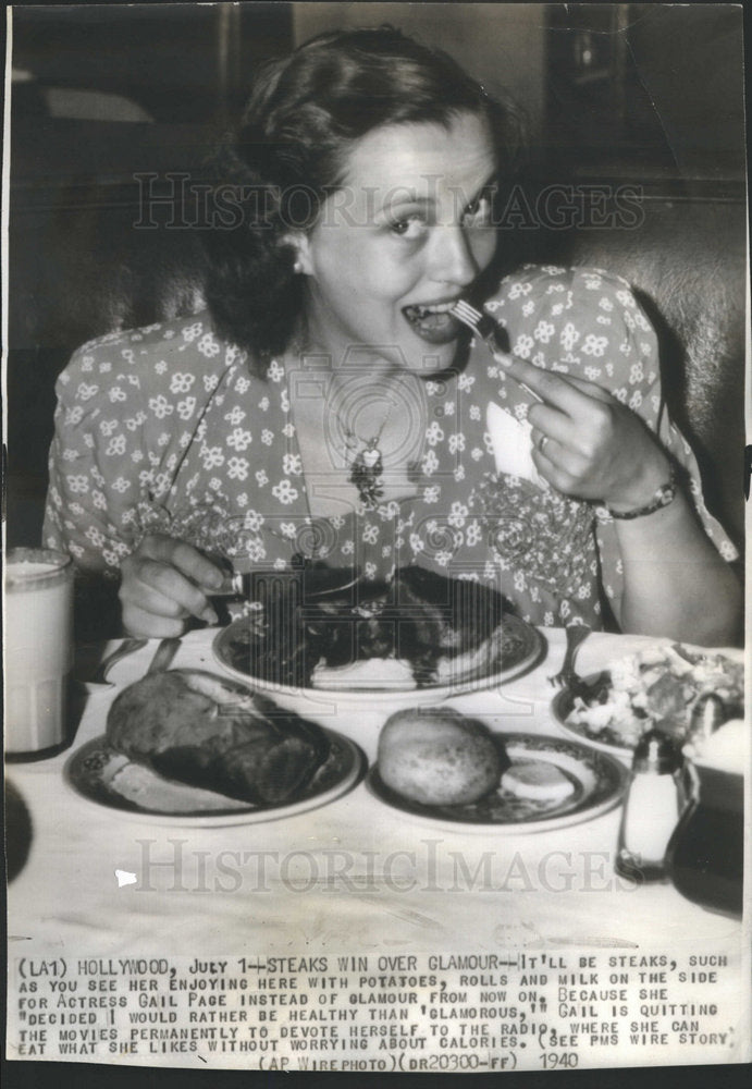 1940 Gail Page Eating Steak - Historic Images