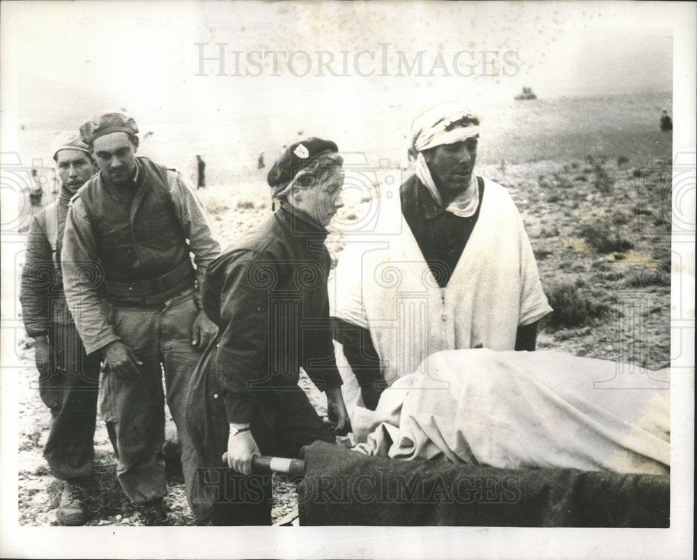 1957 Press Photo Parachute Nurse Christine De Merville Aids Survivor  Massacre - Historic Images