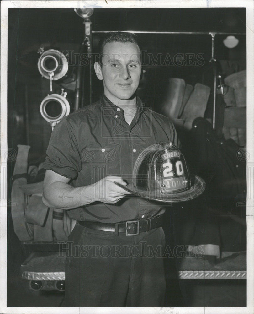 1957 Press Photo Fireman Frank Restivo Looking To Locate Missing Helmet - Historic Images