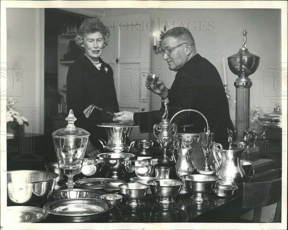 1964 Press Photo Mr. and Mrs. James McAlvins and golf trophies he has won - Historic Images