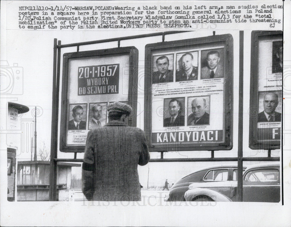 1957 Press Photo Man Studies Election Posters in Poland - Historic Images