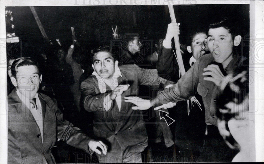 1956 Press Photo Demonstrators after Peruvian election try to harm photographer - Historic Images