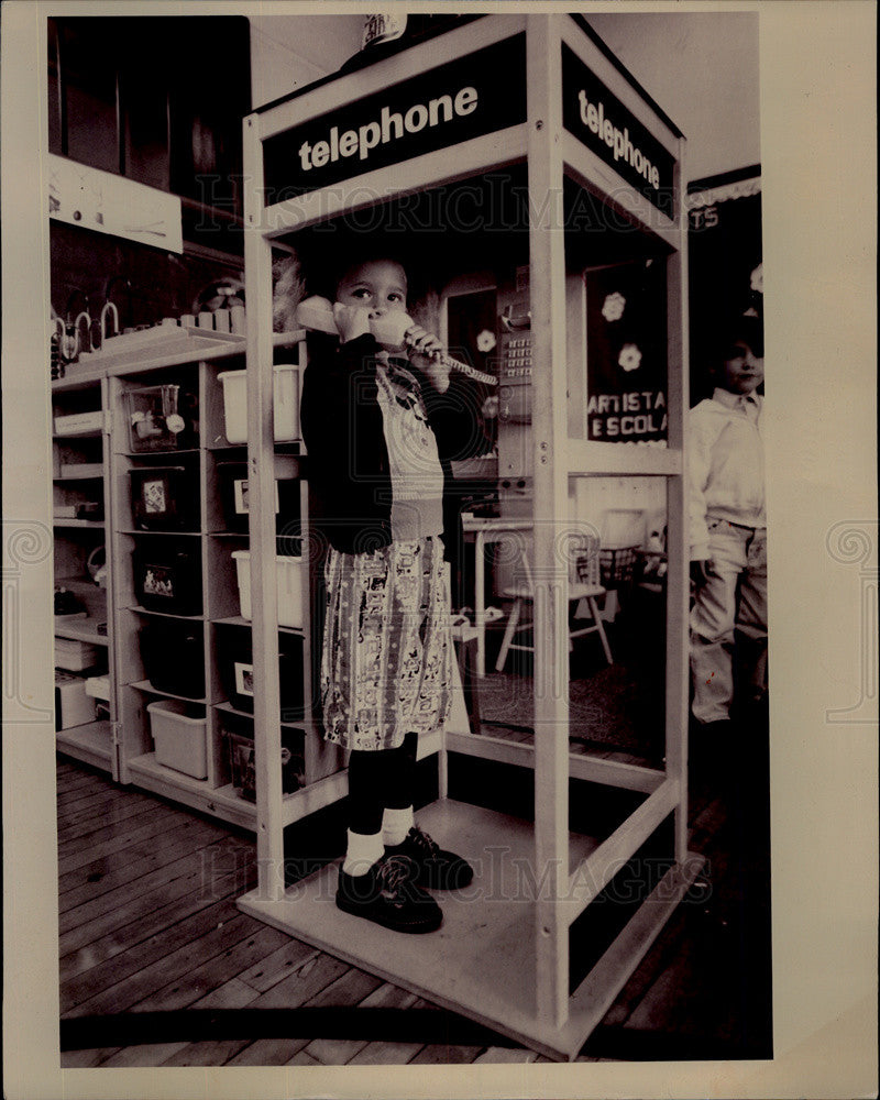 1993 Press Photo Ivelisse Aponte plays with toy phone booth. - Historic Images