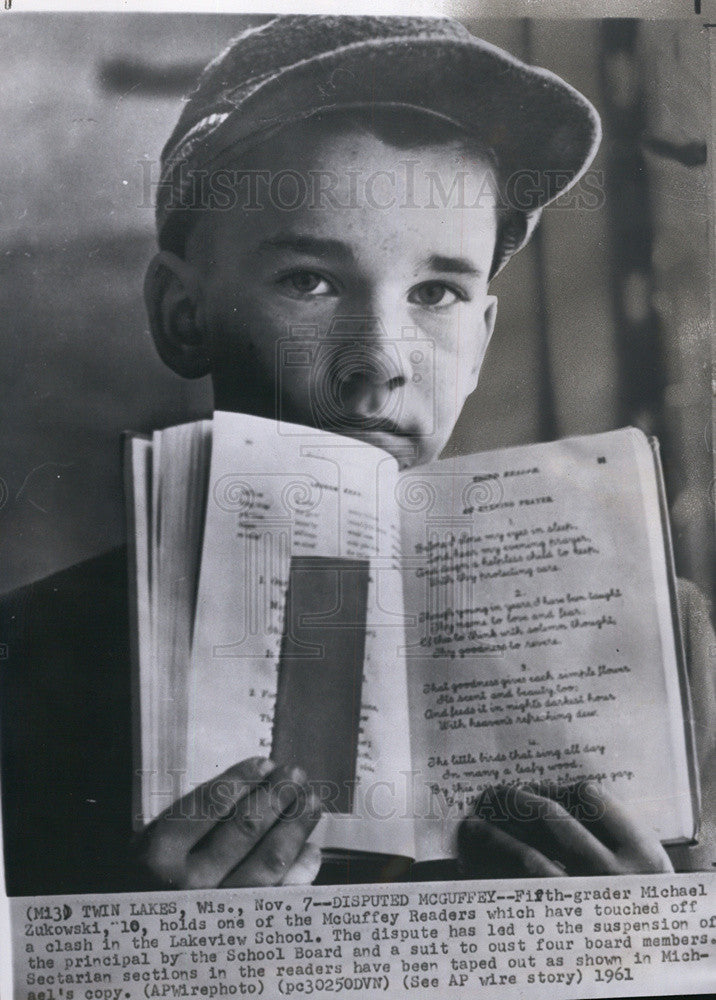 1961 Press Photo Michael Zukowski holds McGuffey Reader with sectarian section - Historic Images