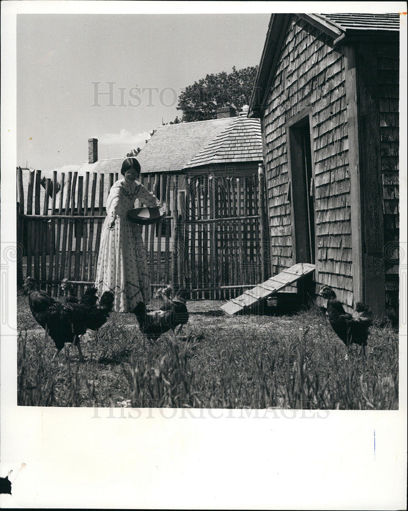 Press Photo Woman Feeding Chickens At Home In New Brunswick, Canada - Historic Images