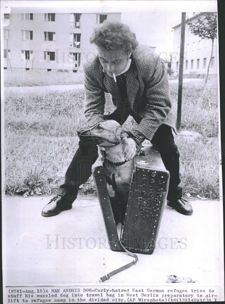 1961 Press Photo East Germany Refugee Tried To Pack His Dog In Suitcase For Trip - Historic Images