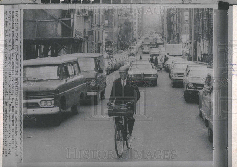 Press Photo Dr. Reynald H.Chase, rides a bike to work. - Historic Images