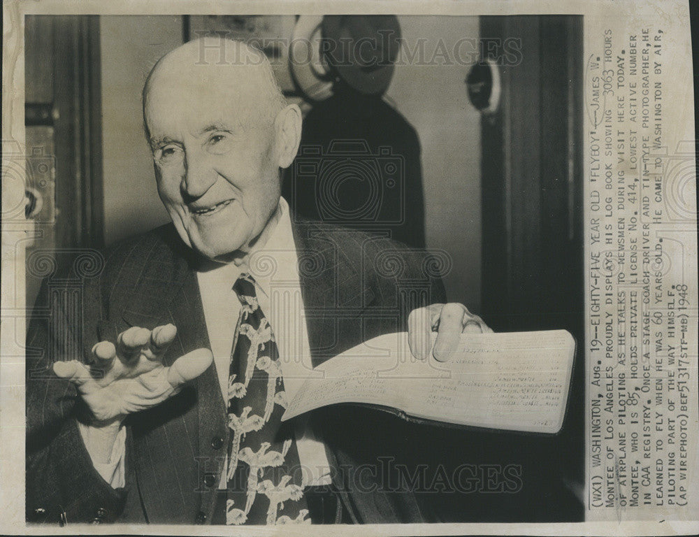 1948 Press Photo James W Montee displays log book showing 3063 hours of piloting - Historic Images