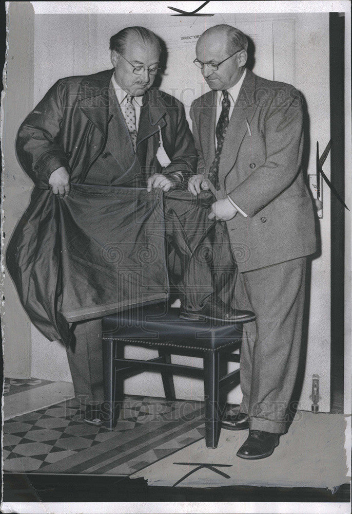 1953 Press Photo of two men holding Overcoat. - Historic Images