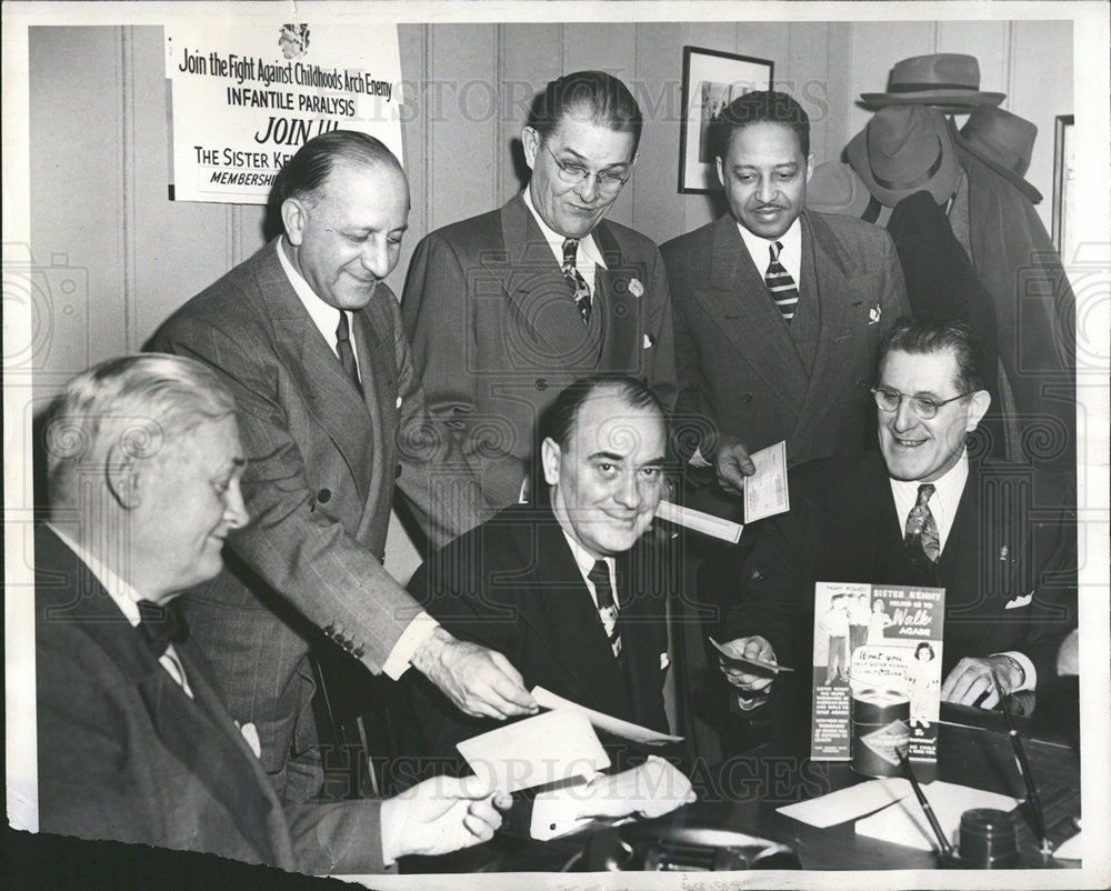 1948 Press Photo Joe Plunkett receives checks for Sister Kenny Polio Fund. - Historic Images