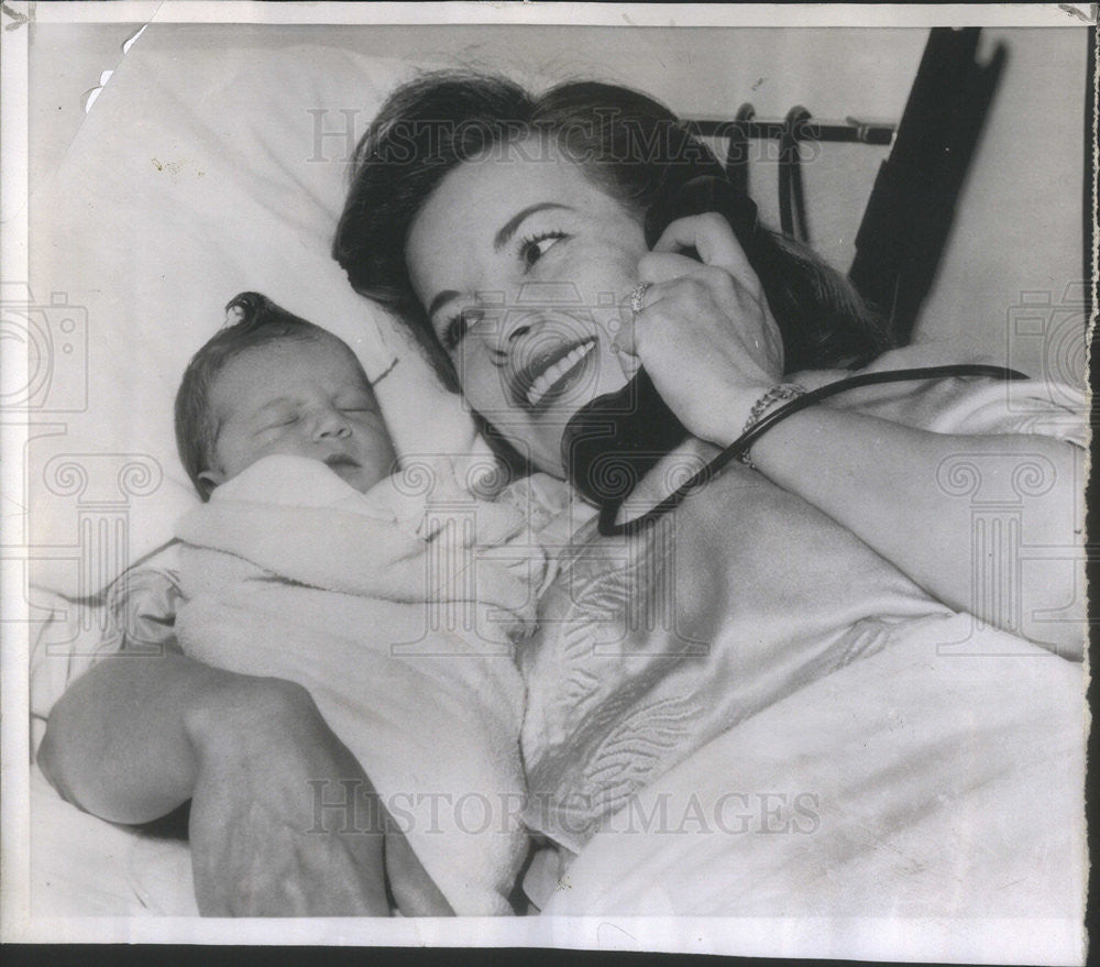 1955 Press Photo Actress Madge Meredith holding infant Christina on the phone - Historic Images