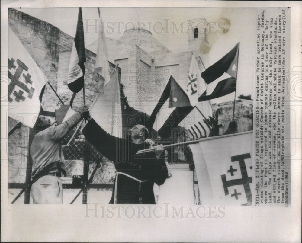 1964 Press Photo Franciscan father Agostino supervising putting of flags - Historic Images