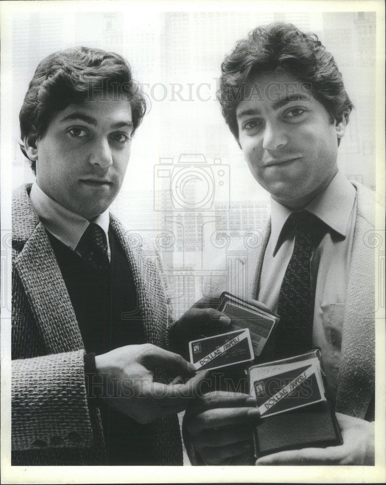 1981 Press Photo Brothers Steven and Michael Mann display their Dollar Savers - Historic Images