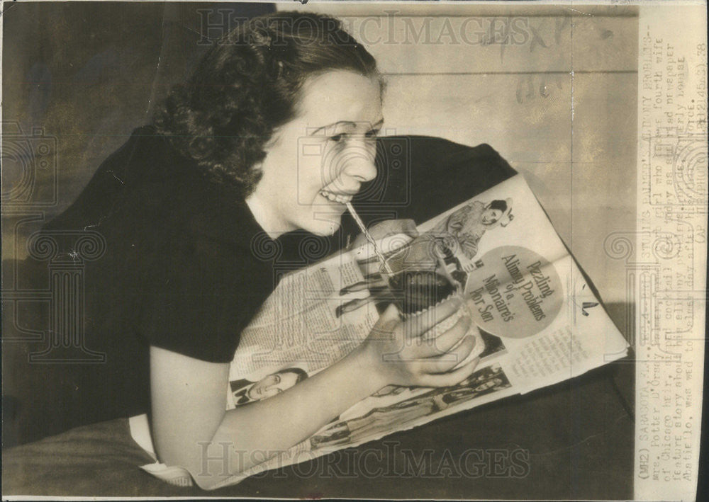 1978 Press Photo Mrs. Potter Palmer sips a cocktail, while reading newspaper - Historic Images