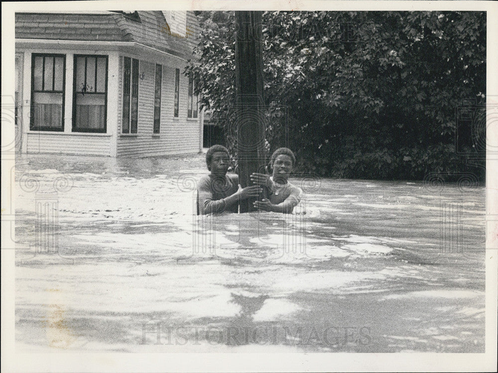 1981 Press Photo Youths cling at light pole in Joliet St., waiting for rescue - Historic Images