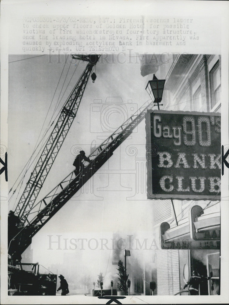 1962 Press Photo Fireman fights fire at Golden Hotel, in Reno. - Historic Images