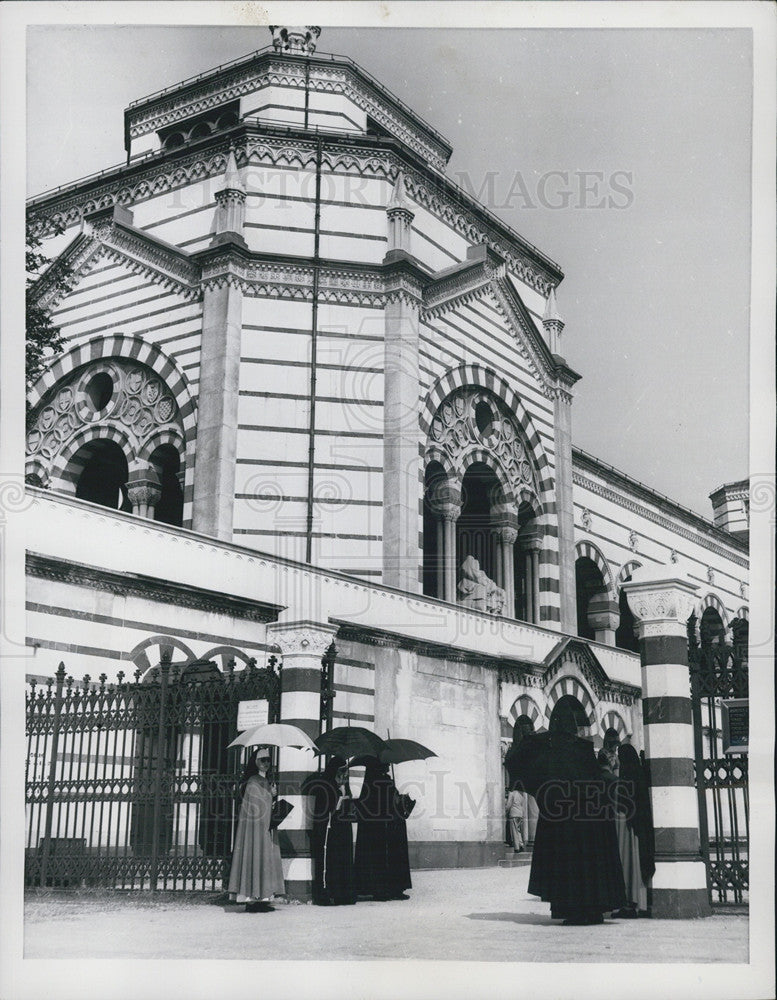 1955 Press Photo Monumental entrance Milan cemetery nuns umbrellas Italy - Historic Images