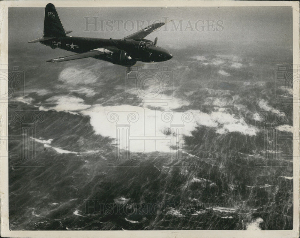 Press Photo US Navy Plane Flies High Over Stormy Waters Hurricane Carol Florida - Historic Images