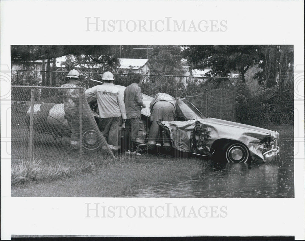 1987 Press Photo Firefighters Driver Car Accident Flipped Steven Kupelian - Historic Images