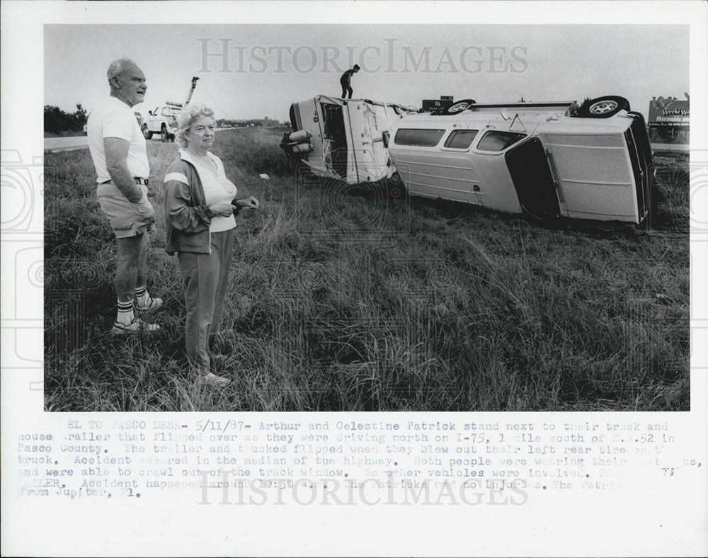 1987 Press Photo Arthur &amp; Celestine Patrick stand by their flipped truck &amp; - Historic Images