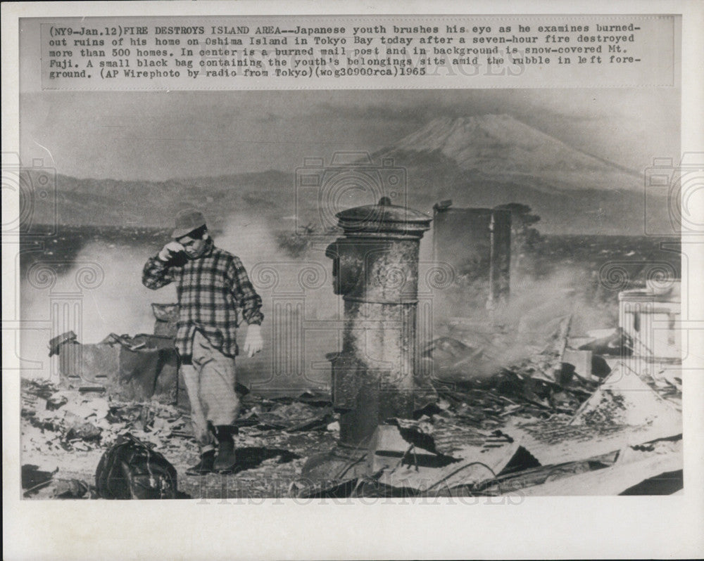 1965 Press Photo Youth Examines Homes Fire Destroyed  In Oshima Island,Tokyo Bay - Historic Images