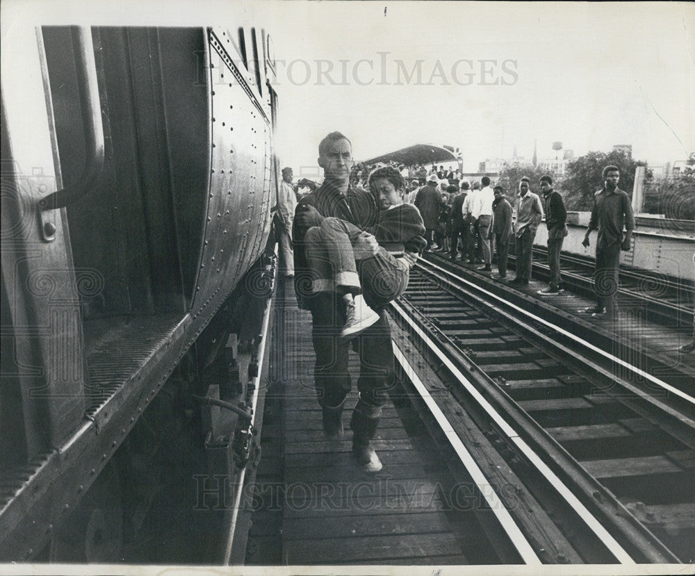 1969 Press Photo Fireman Carries Injured Boy From Derailed L Train In Chicago - Historic Images