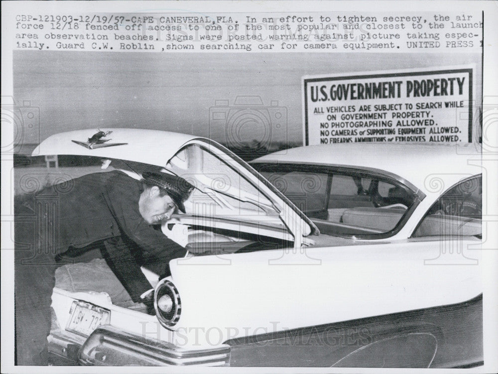 1957 Press Photo Guard CW Roblin inspecting the car of a visitor of Cape Canaveral Fla - Historic Images