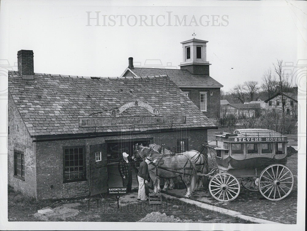 1957 Press Photo in front of a reconstructed blacksmith shop at Shelburne Museum - Historic Images