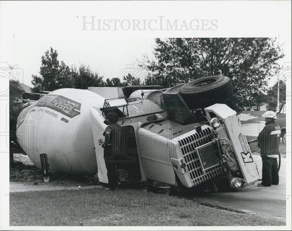 1985 Press Photo Overturned cement truck lies in yard on Seven Springs Blvd - Historic Images