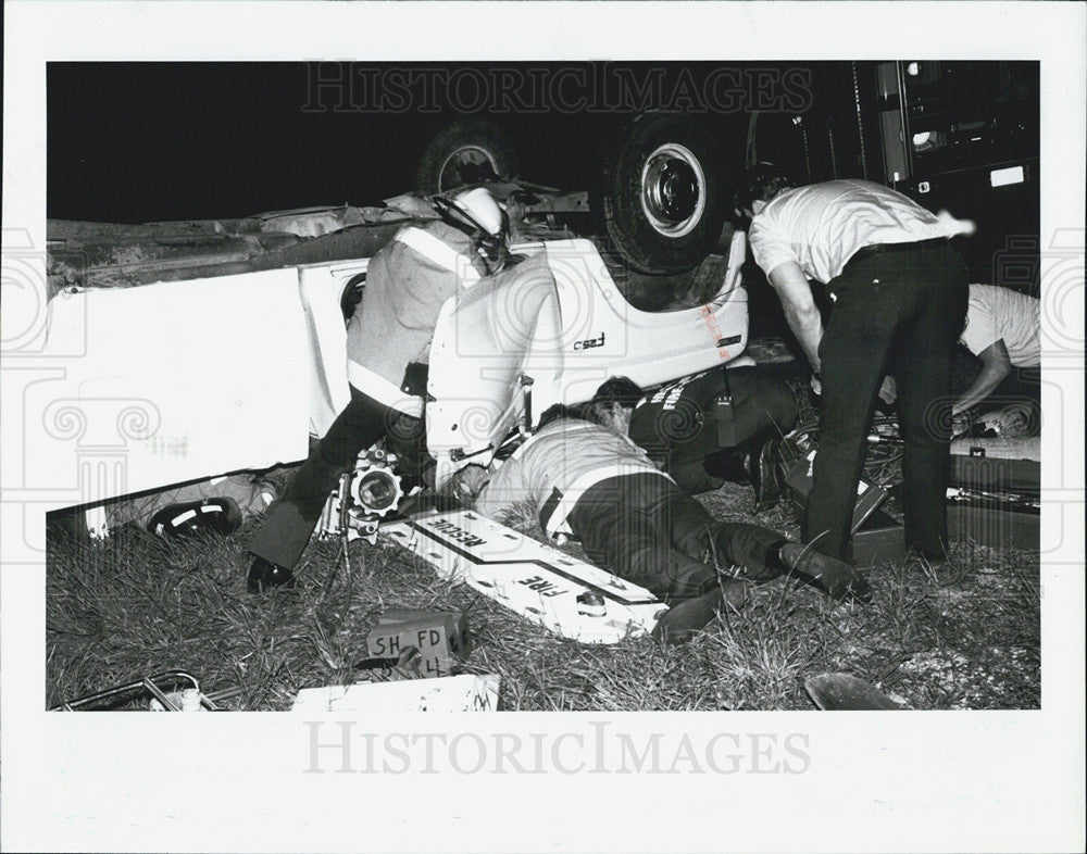 1988 Press Photo Rescue workers cut through an overturned truck to save Dennis Deluca - Historic Images