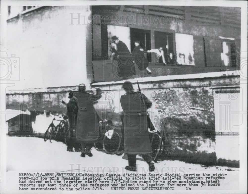 Press Photo Romanian Charge d&#39;Affaires Emeric Steffel carries 8yr old son - Historic Images